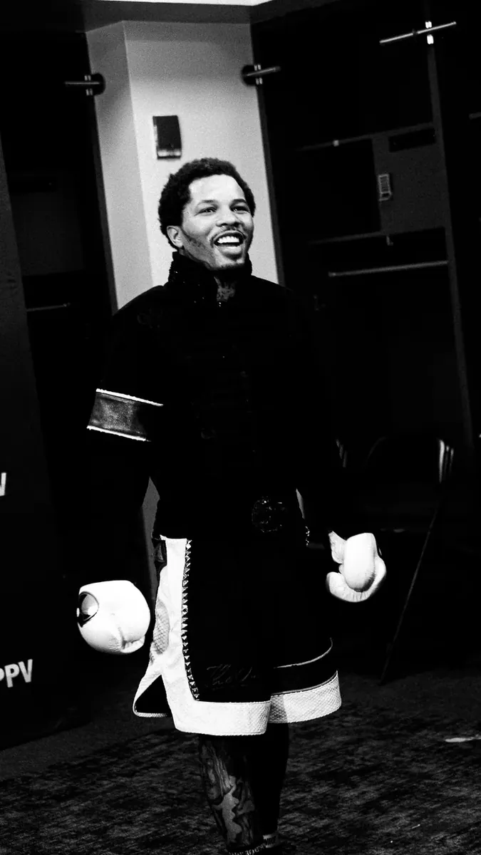 Fighter in his walkout robe holding gloves